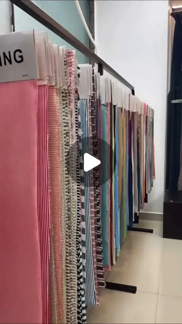 Reel cover: knitted fabric swatches on a hanger display at DG Knitting